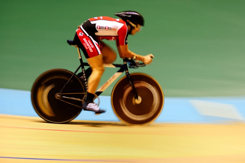 a man riding a bike through a track