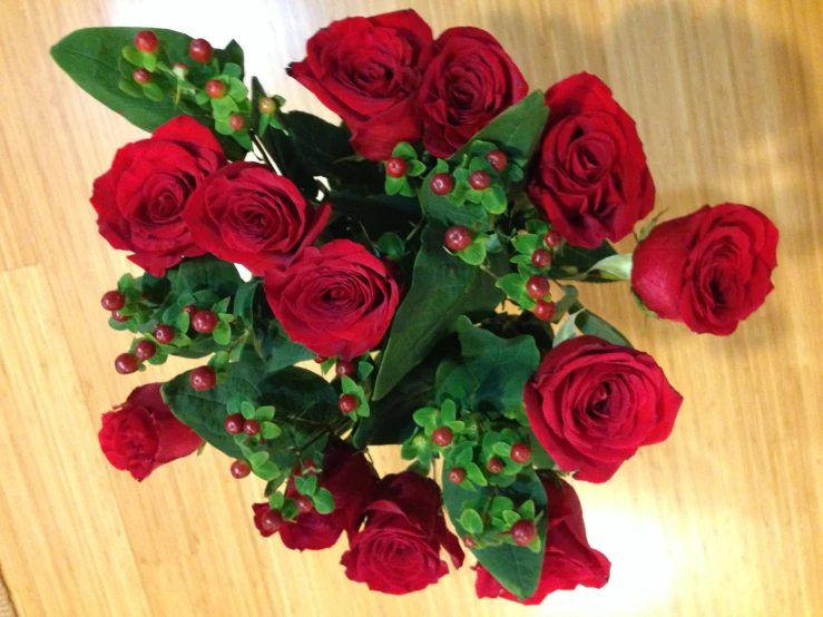 a bouquet of red roses are on the table