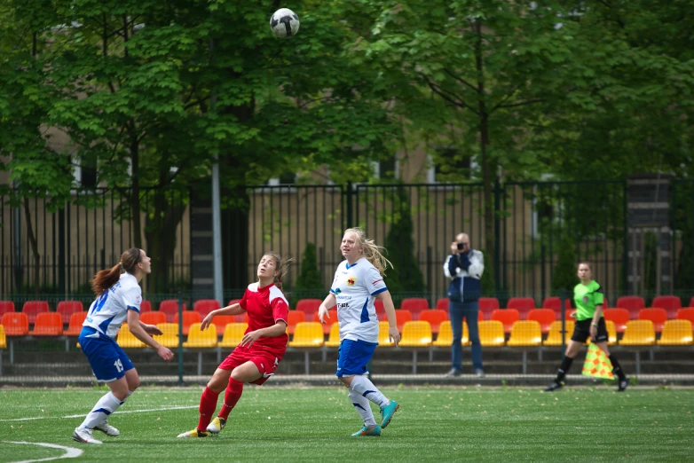 a group of young women playing a game of soccer