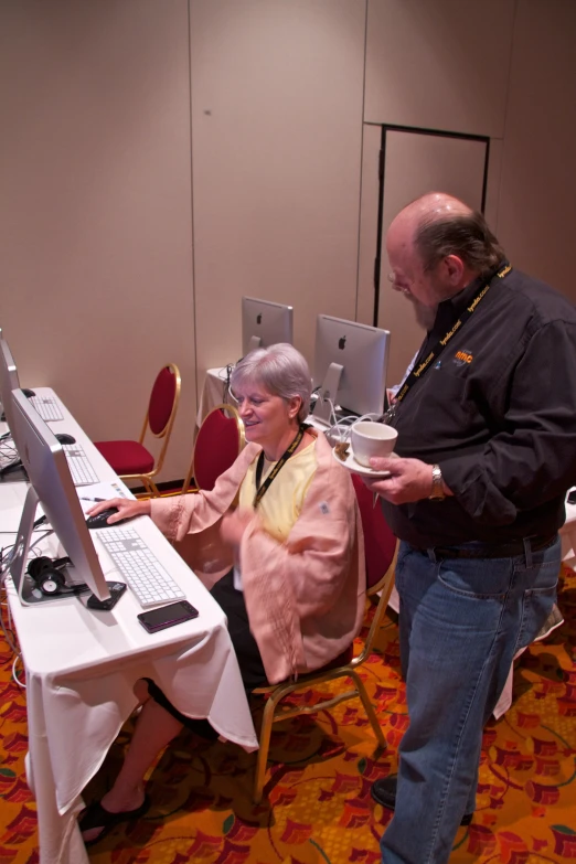 man and woman looking at the screen on a computer