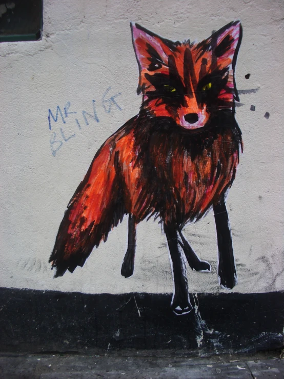 an orange and brown fox on the side of a building