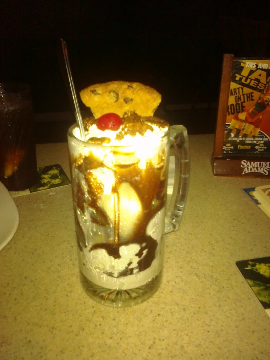 a large mug with ice cream and a large gummy bear head