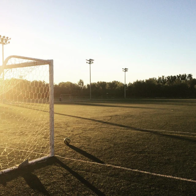 an empty soccer field with a goal