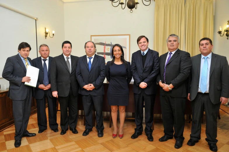 a group of business people standing next to each other