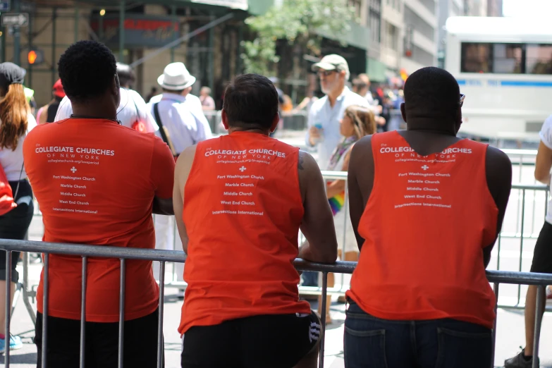 group of men in orange vests looking at traffic