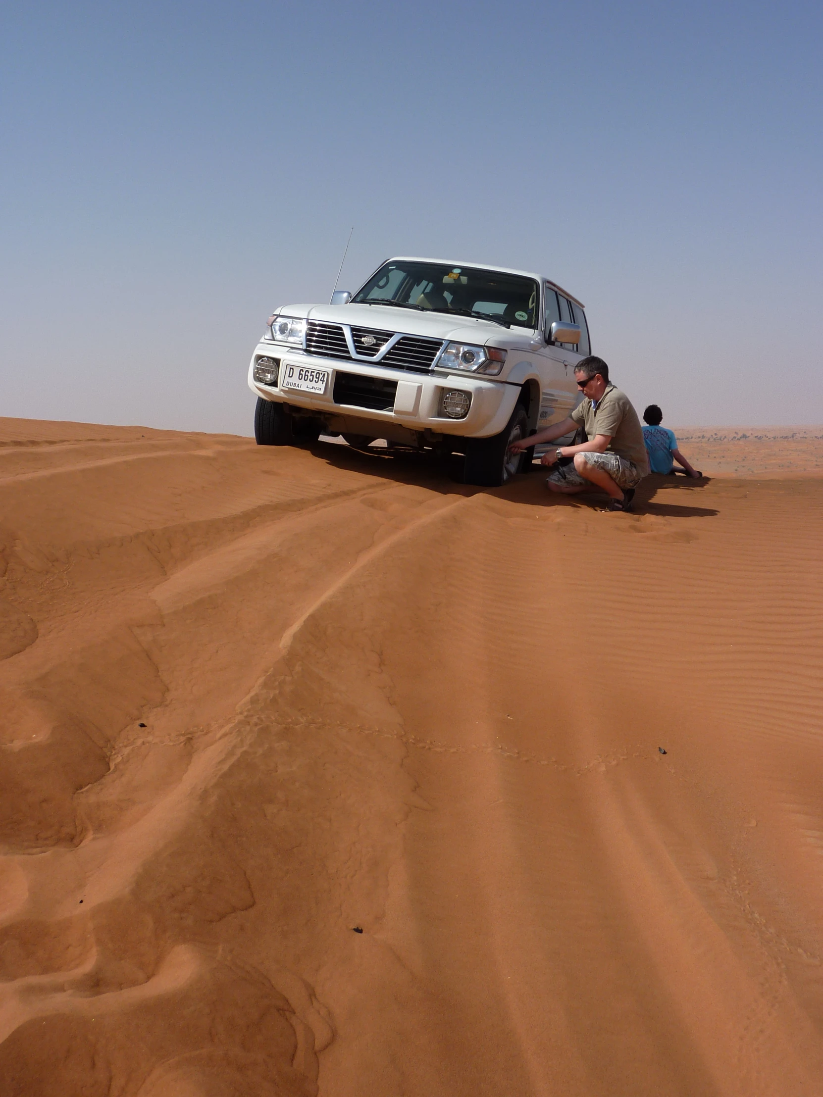 people are in the desert getting into a car