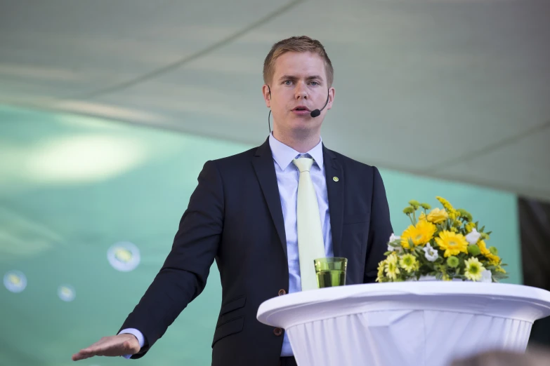 a man giving a presentation with his hand out at an audience