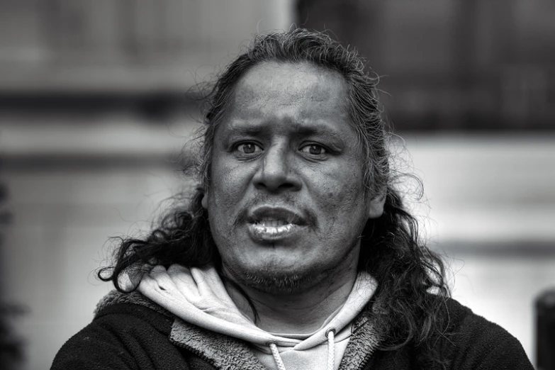 a man with long hair is looking at the camera