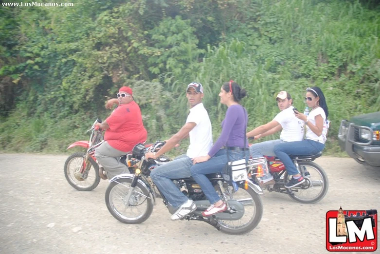three people are riding motorcycles with other motorcyclists