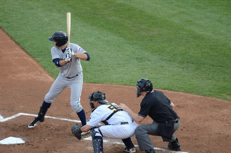 a baseball player holding a bat next to home plate