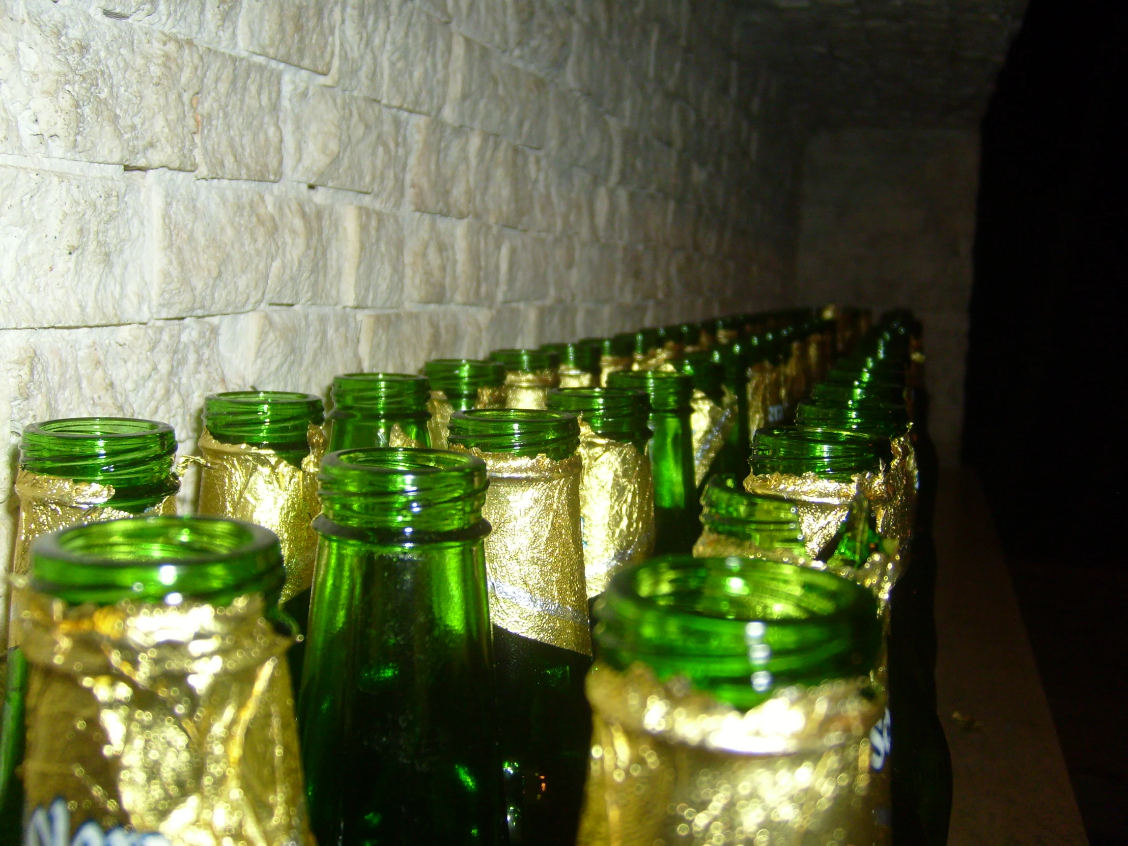 many green and yellow jars sit on a table