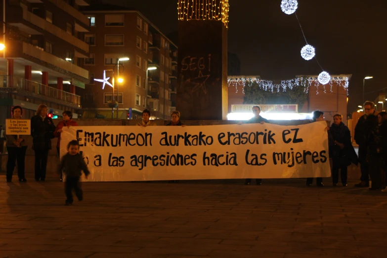 a group of people holding signs in the street