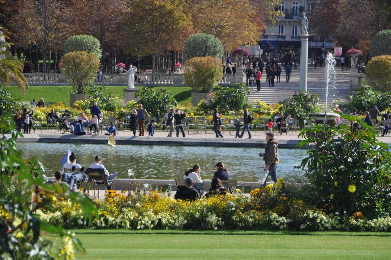 people are walking by water and in the park