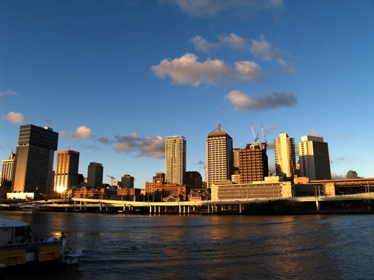 a very tall city near a river in the daytime