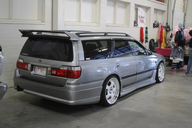 a car parked in a garage with lots of clothes on it