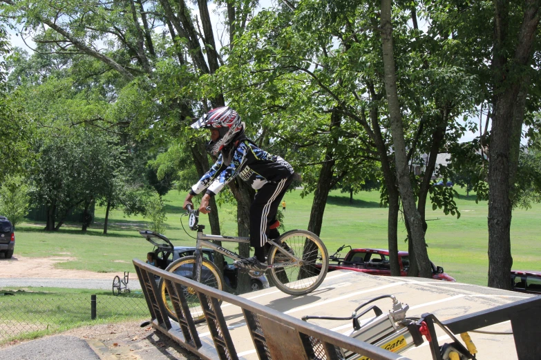 person on a bike jumps over a ramp in the woods