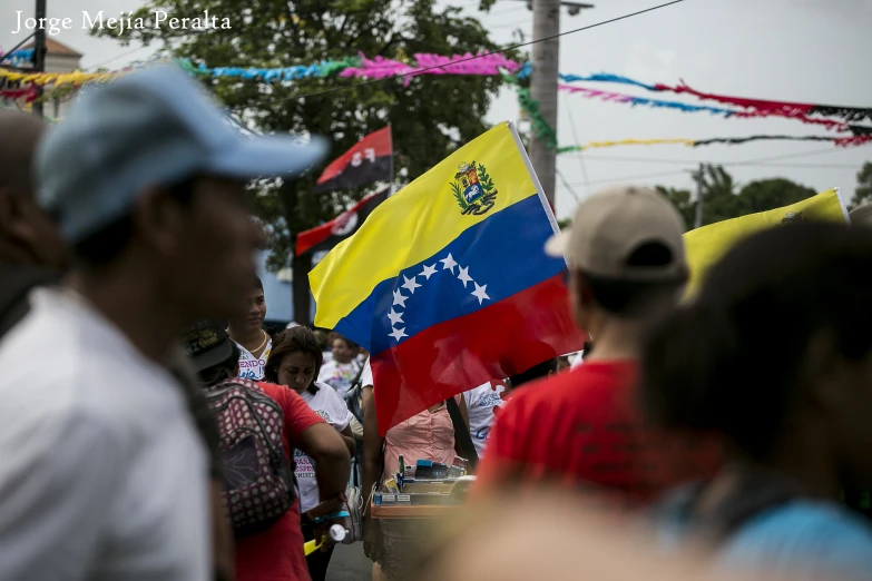 people are walking with many flags as one man carries a trumpet