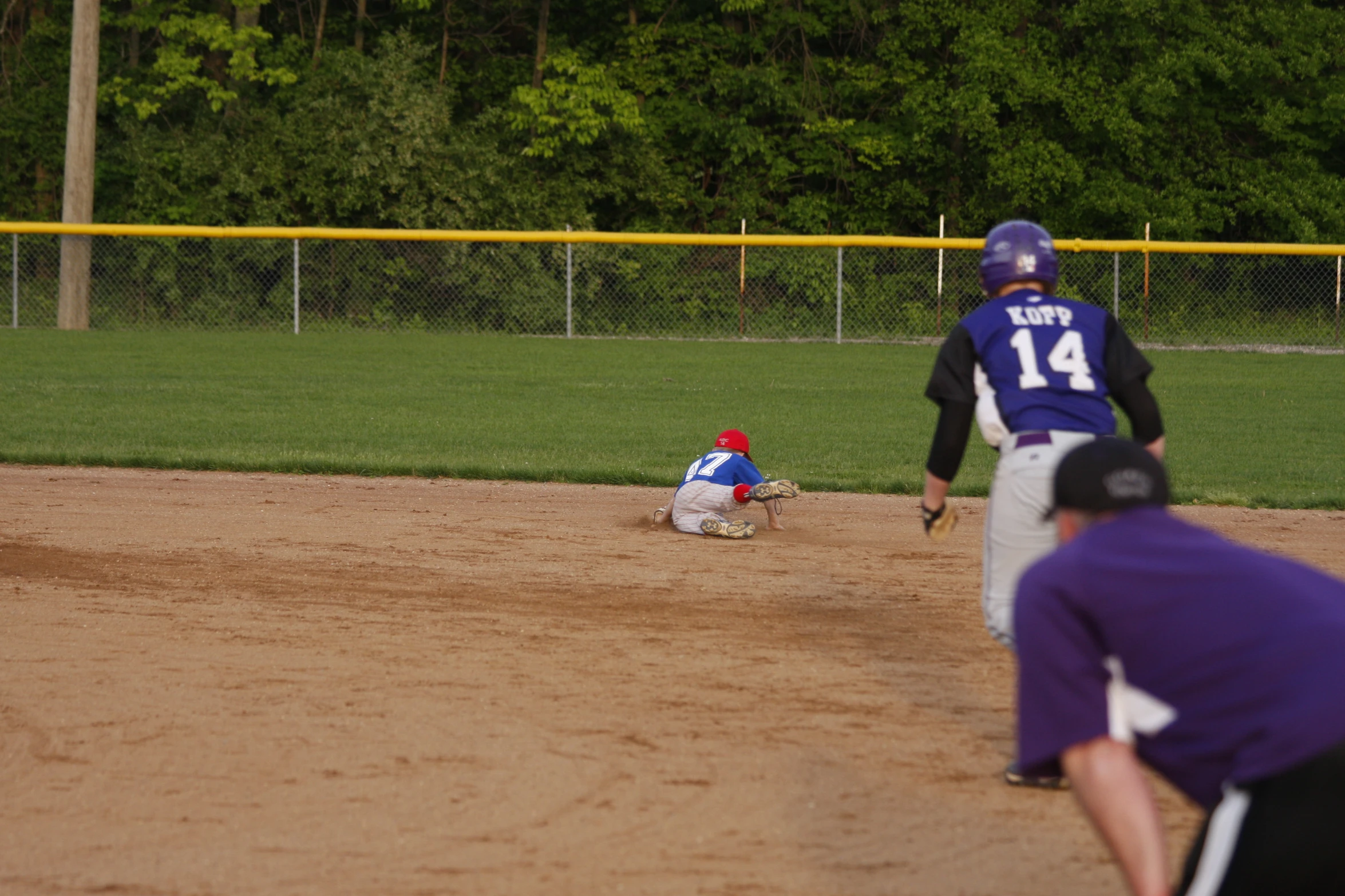 the young man is trying to tag the ball in the game