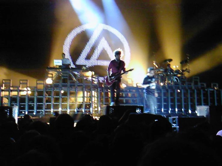 concert scene at night with band playing in front of large crowd