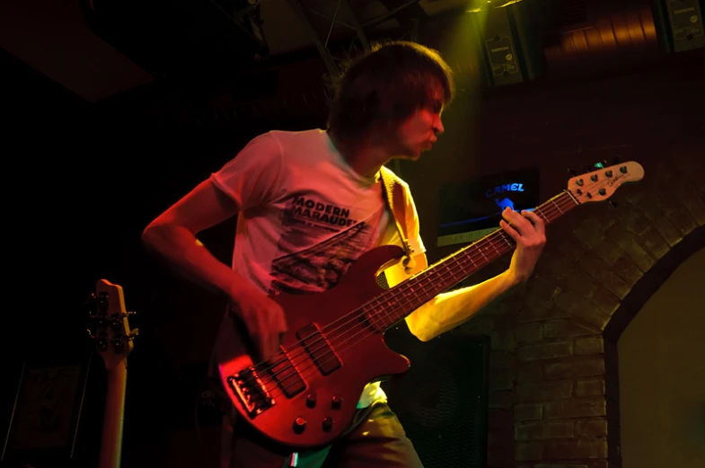 a man that is standing up with a guitar