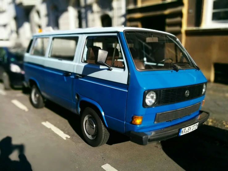 a blue van is parked on the side of the street