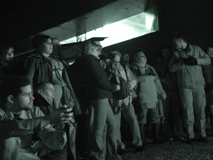 several people watching soing as they stand on a field