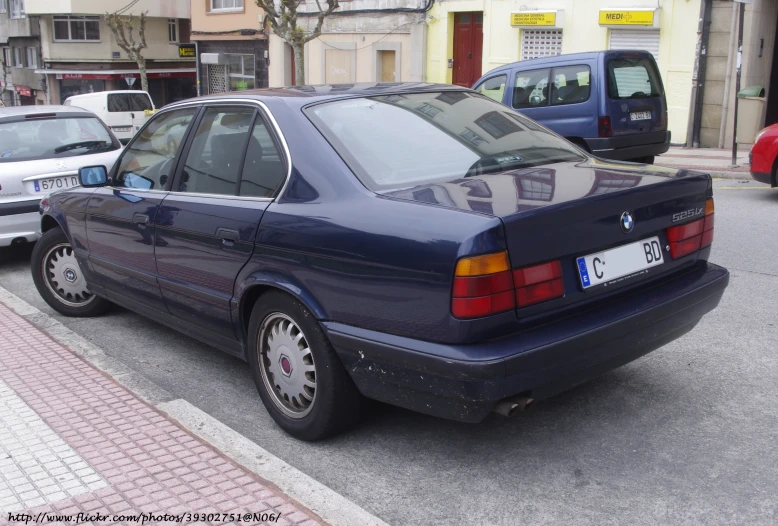 the car is parked at a curb in the city