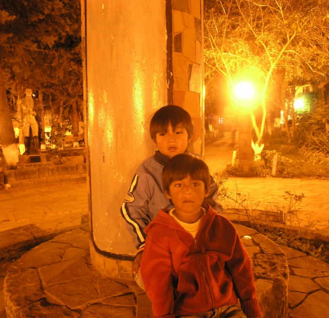 two little s sitting next to each other on the steps