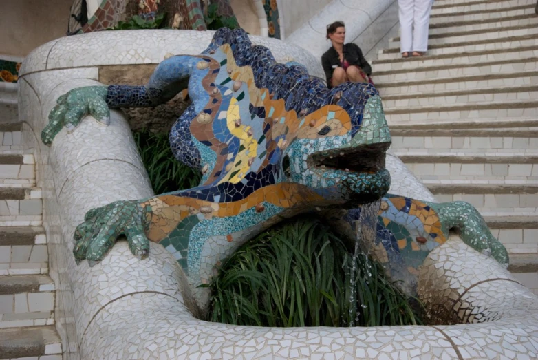 the lizard statue has been decorated with multiple colors and patterns