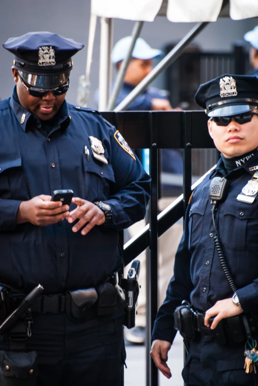 two police officers using a mobile phone