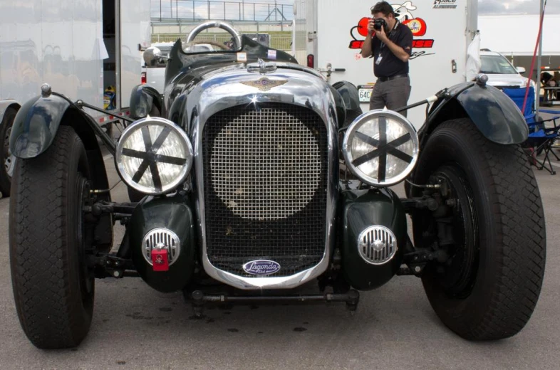 a vintage car with all four front wheels off the ground