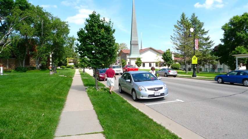 there is a car parked at the curb of a street