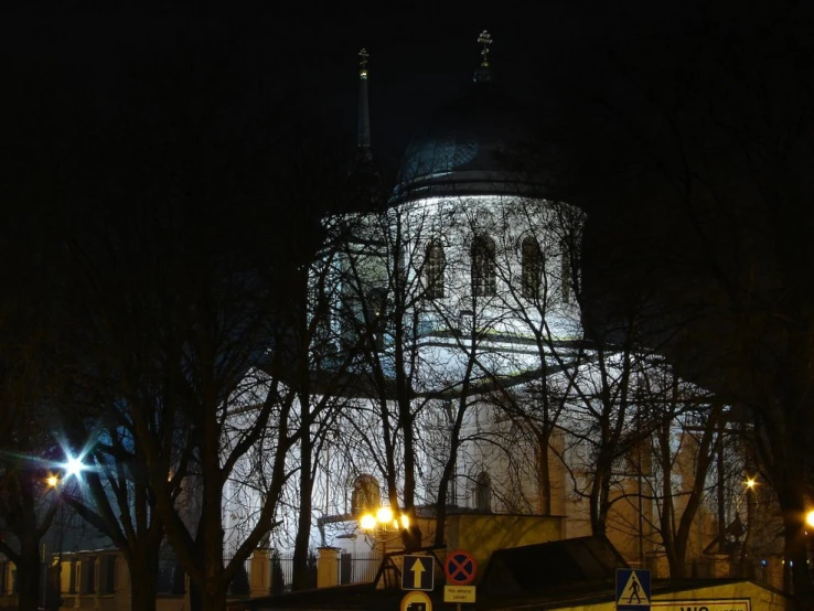 the clock tower of a large church at night