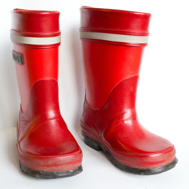 red rubber boots on a white background are shown