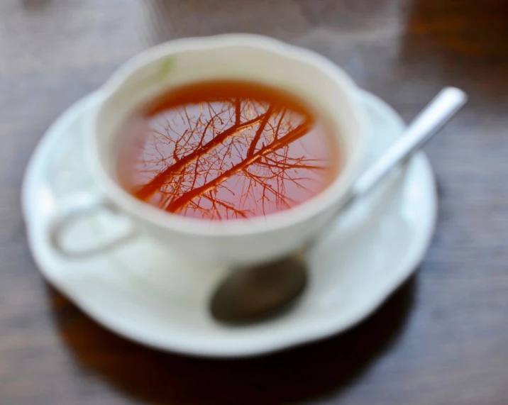 a cup with liquid inside and a spoon in it