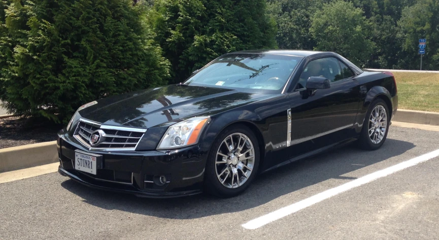 a black car is parked in the parking lot