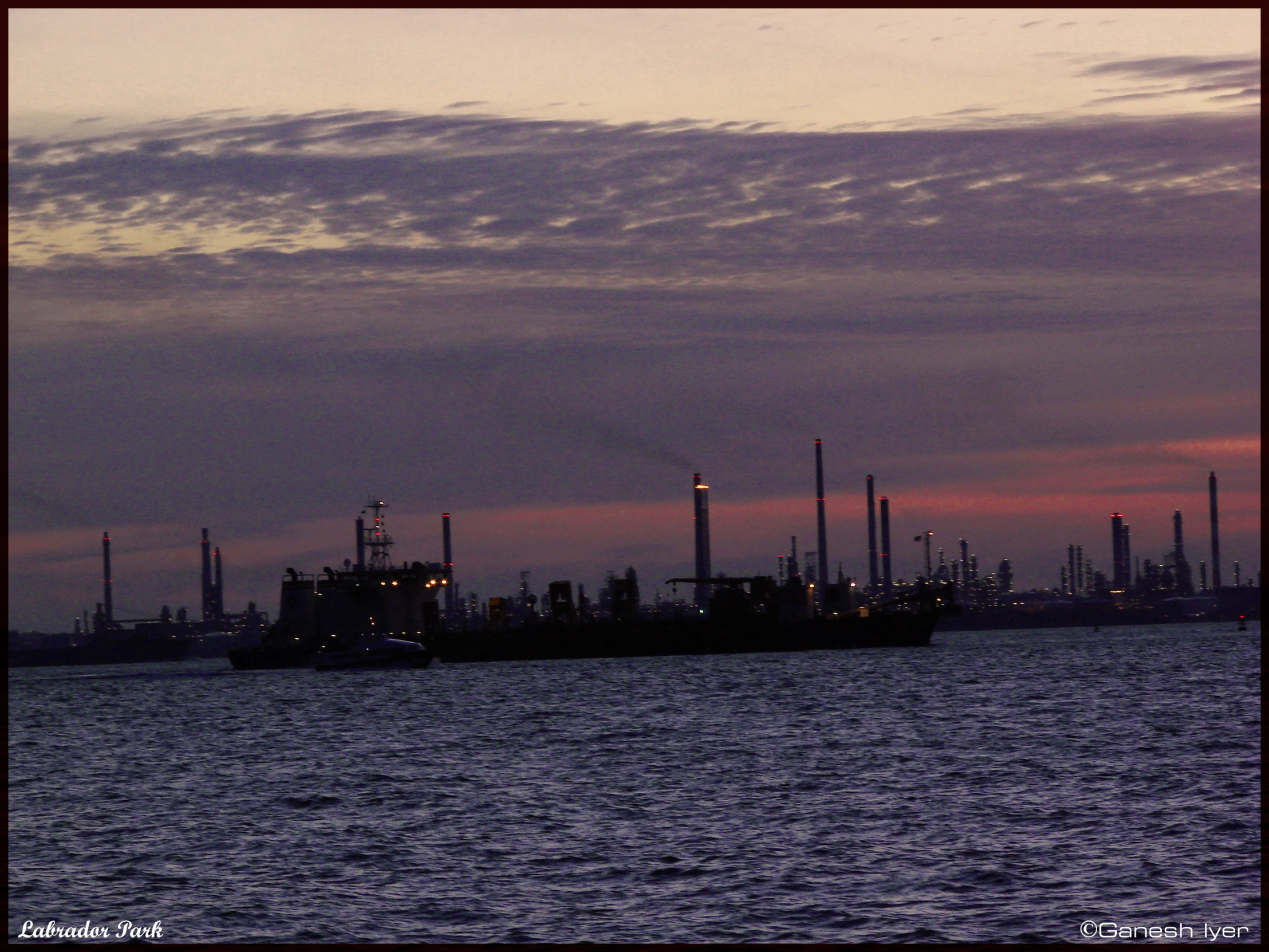 this is a view of a boat with smoke stacks in the sky