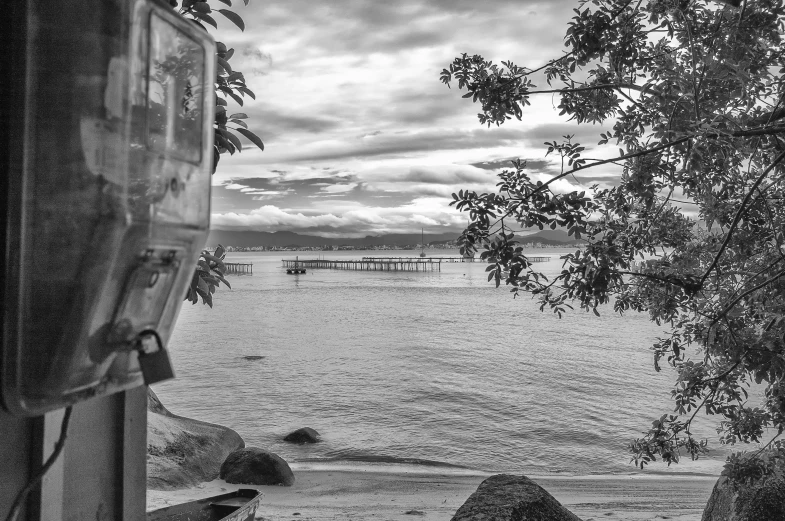 a black and white po of the beach with water in the background