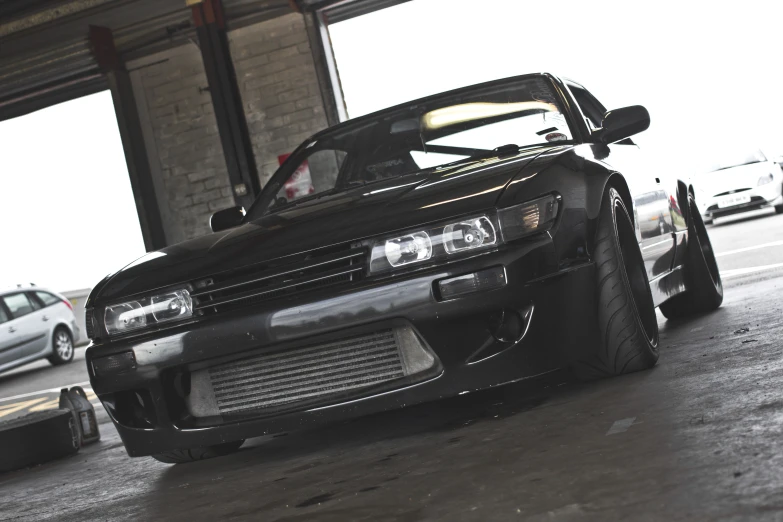 a black car parked under an overpass