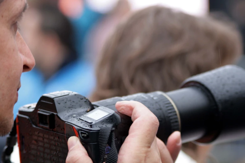 a man holding his camera and taking pictures