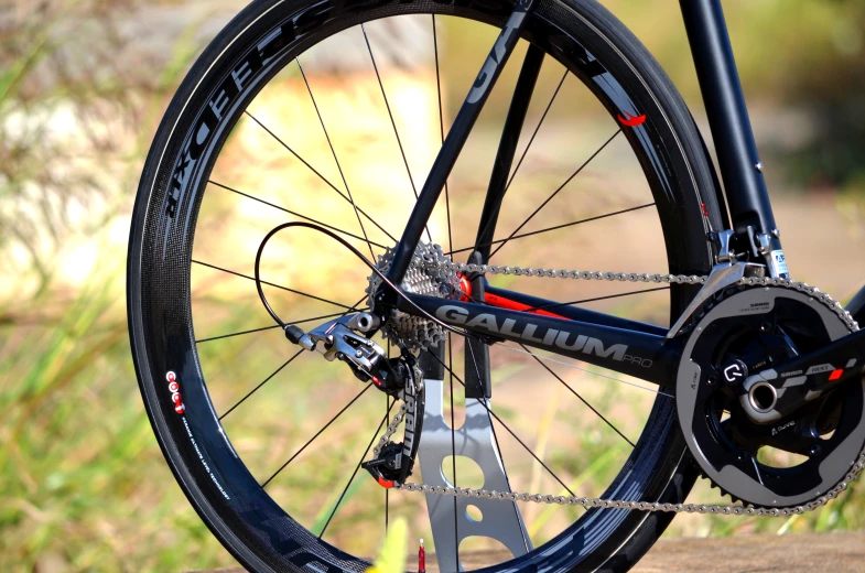 a close - up of a bike parked near grass and trees