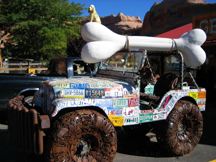 an antique truck decorated with stick and bones