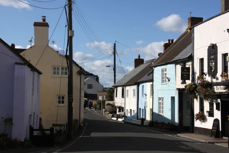 a narrow street in a small city with tall buildings