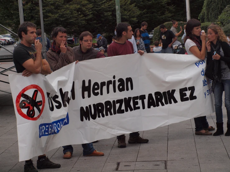 several people holding a banner that says german