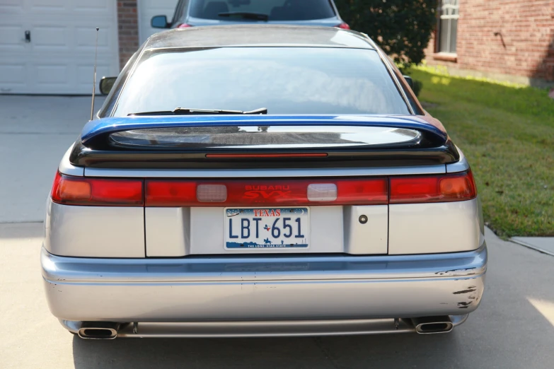 a rear view image of a silver car on the road