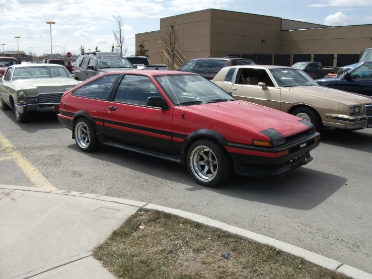 a car parked in the lot next to other cars