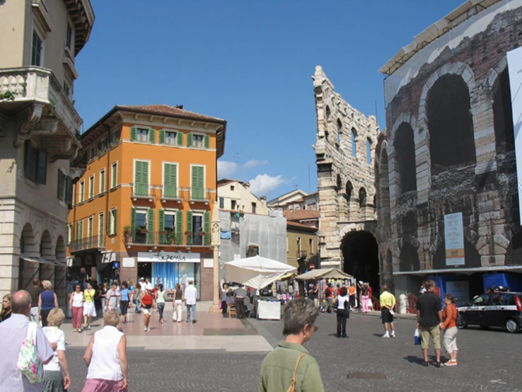 a city square with cars and people in it