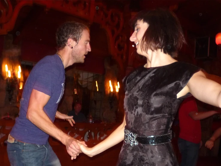 a couple holding hands in a restaurant at night