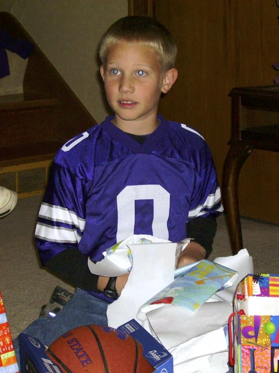 a  wearing a football jersey and some gift wrapping