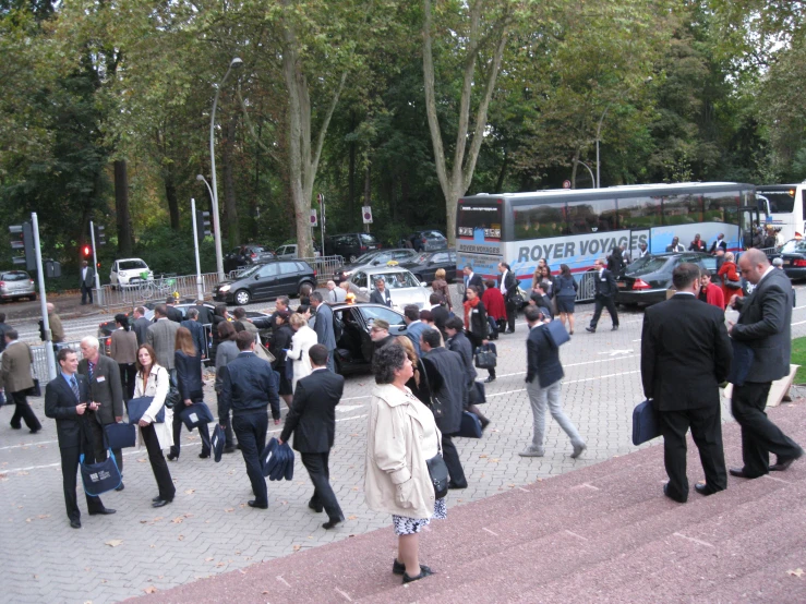 a bunch of people that are standing by a street